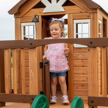 Backyard Discovery Echo Heights Elevated Cedar Wooden Kids Playhouse with Wave Slide, Play Kitchen, Wrap-Around Deck, Flat-Step Ladder, Half Door, Windows, Bell, and Growth Chart for Outdoor Play