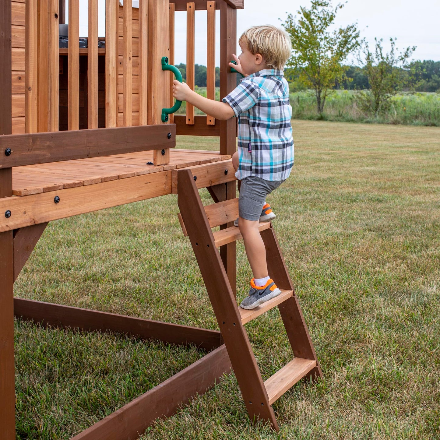 Backyard Discovery Echo Heights Elevated Cedar Wooden Kids Playhouse with Wave Slide, Play Kitchen, Wrap-Around Deck, Flat-Step Ladder, Half Door, Windows, Bell, and Growth Chart for Outdoor Play