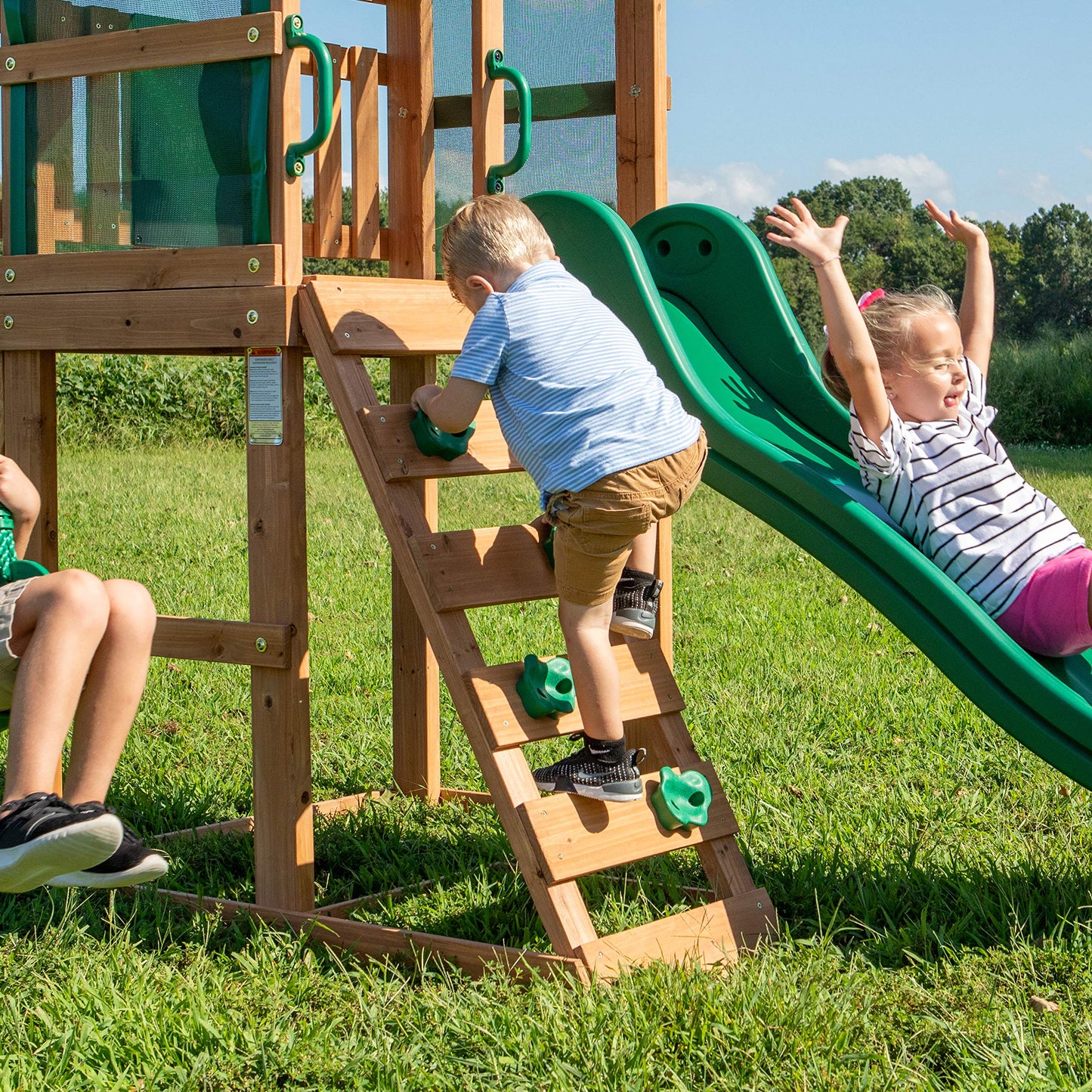 Backyard Discovery Buckley Hill Cedar Wood Swing Set with Wave Slide, Play Deck, Rock Wall Ladder, Belt Swings, Chalkboard, Canopy Roof, Outdoor Playset
